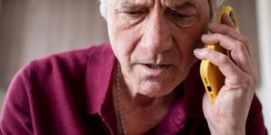 Person on a cellphone looking at a credit card